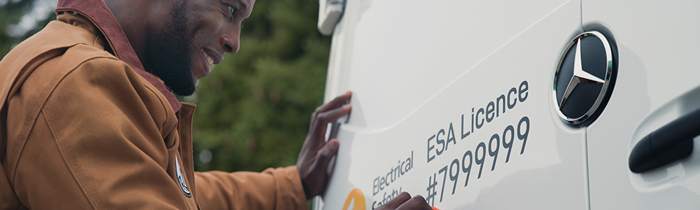 Man at back of van with ESA licence number