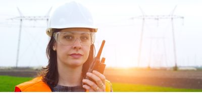 female engineer in from of powerlines