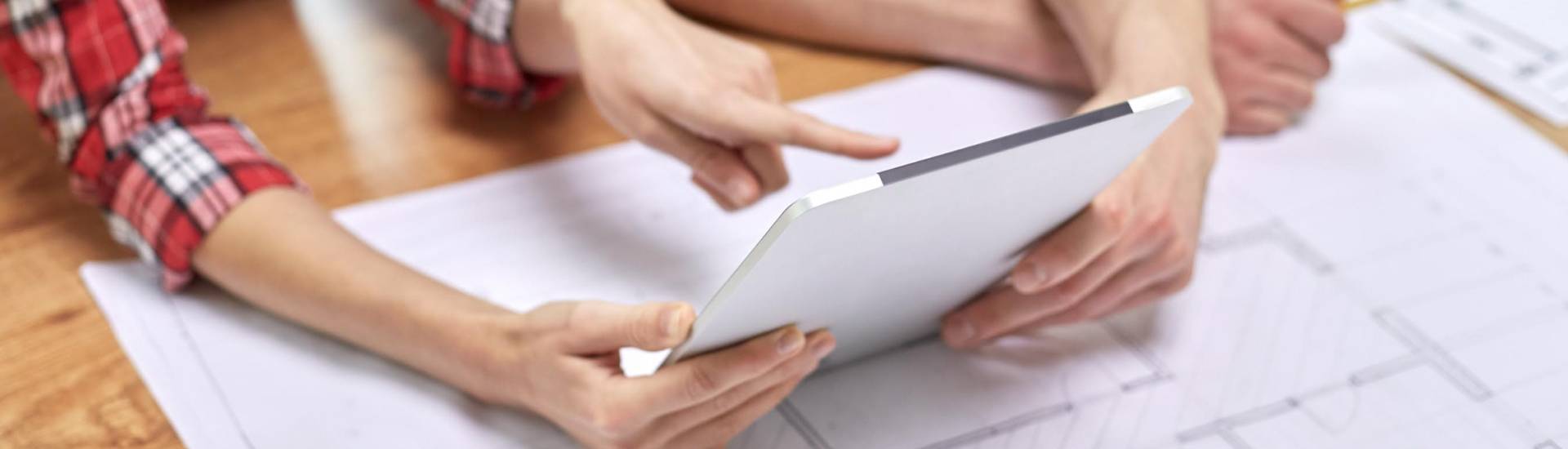 two people looking at a tablet